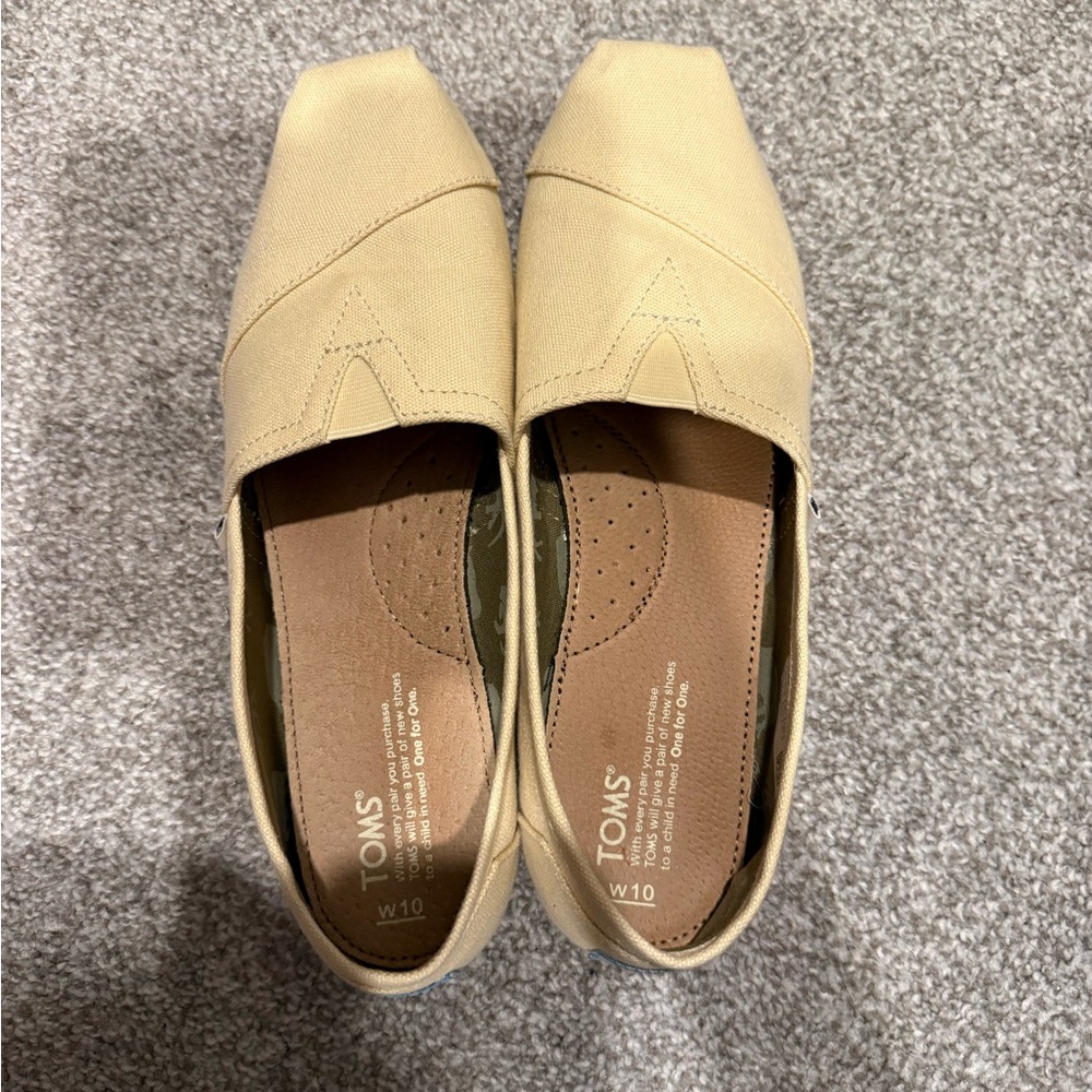 TOMS Women's Classic Canvas Slip-On Flats in Pale Yellow